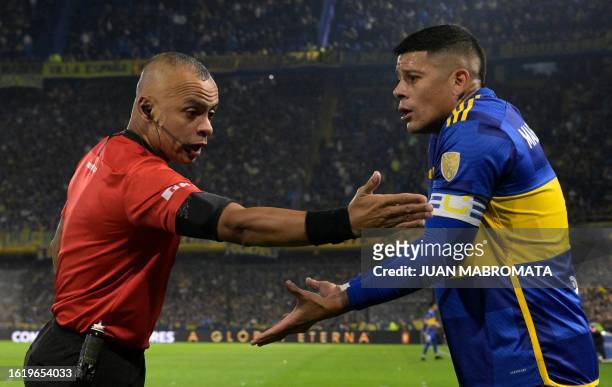 Brazilian referee Wilton Pereira Sampaio speaks to Boca Juniors' defender Marcos Rojo during the all-Argentine Copa Libertadores quarterfinals first...