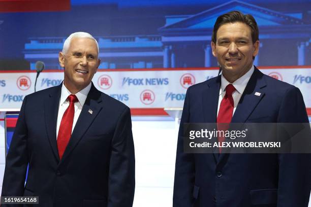 Former US Vice President Mike Pence and Florida Governor Ron DeSantis arrive on stage for the first Republican Presidential primary debate at the...