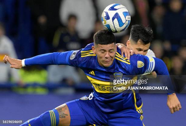 Boca Juniors' defender Marcos Rojo and Racing's defender Leonardo Sigali fight for the ball during the all-Argentine Copa Libertadores quarterfinals...