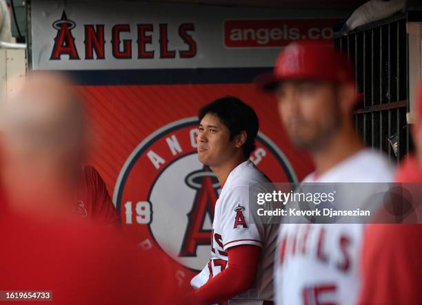 Designated hitter Shohei Ohtani of the Los Angeles Angels looks on in the dugout before the start of game two of a doubleheader against the...