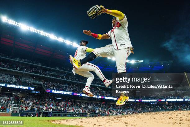 Marcell Ozuna of the Atlanta Braves and Ronald Acuna Jr. #13 high five after the win over the New York Mets at Truist Park on August 23, 2023 in...