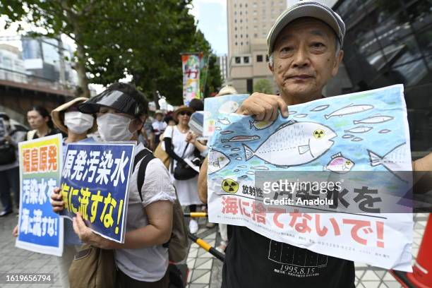 People gather to protest in front of TEPCO, Tokyo Electric Power Company, on August 24 in Tokyo, Japan, as Japan starts to release at sea 7,800 tons...
