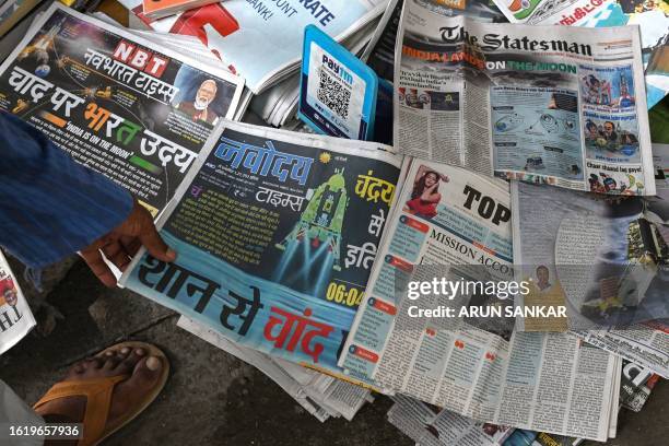 General view of daily newspapers with front pages reporting on successful landing of ISRO's Chandrayaan-3 spacecraft on the south pole of the Moon,...