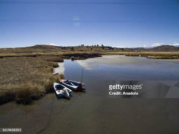 Two boats parked on the shores of the Lake Titicaca, in Huarina, La Paz, Bolivia on August 17, 2023. Lake Titicaca drops its waters to alarming...