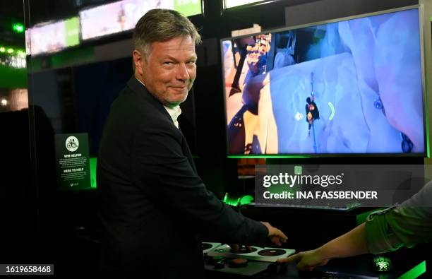 German Minister of Economics and Climate Protection Robert Habeck poses at the booth of Microsoft's XBox as in background can be seen a screen...
