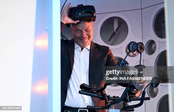 German Minister of Economics and Climate Protection Robert Habeck tries out the environment simulation pod DIVE+, a novel simulator that combines...