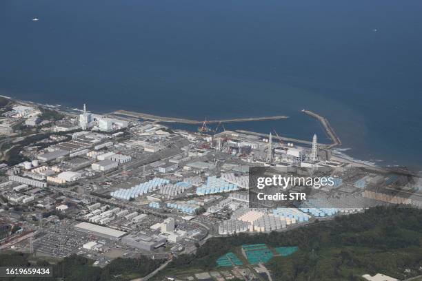 This aerial picture shows storage tanks used for storing treated water at TEPCO's crippled Fukushima Daiichi Nuclear Power Plant in Okuma, Fukushima...