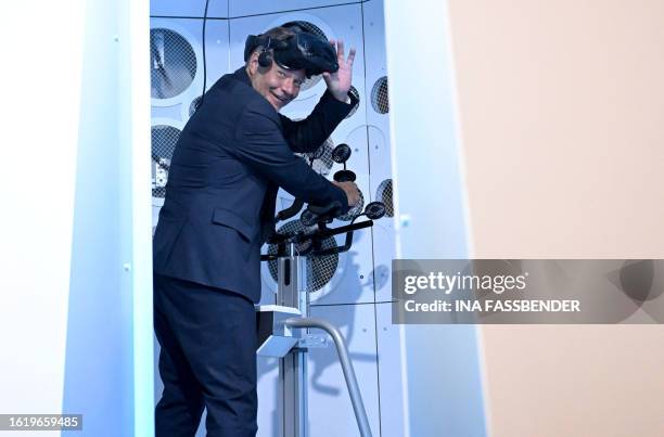 German Minister of Economics and Climate Protection Robert Habeck tries out the environment simulation pod DIVE+, a novel simulator that combines...