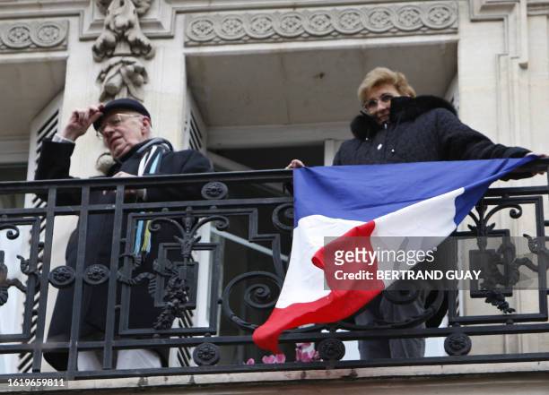 Two persons wave to several thousands people rallying, 18 November 2007 in Paris, to protest against the strike on the fourth day of the nationwide...