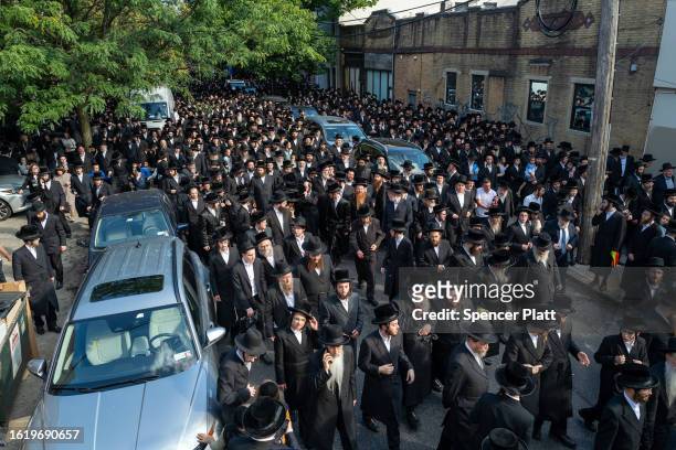 Thousands of Hasidic men converge for the funeral of Rachmastrivka Rebbe in Borough Park Brooklyn on August 16, 2023 in New York City. Rachmastrivka...