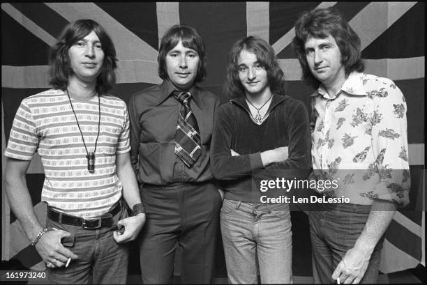 Studio portrait of The Troggs, as they pose before a Union Jack, New York, New York, July 23, 1975. Pictured are, from left, Ronnie Bond , Reg...