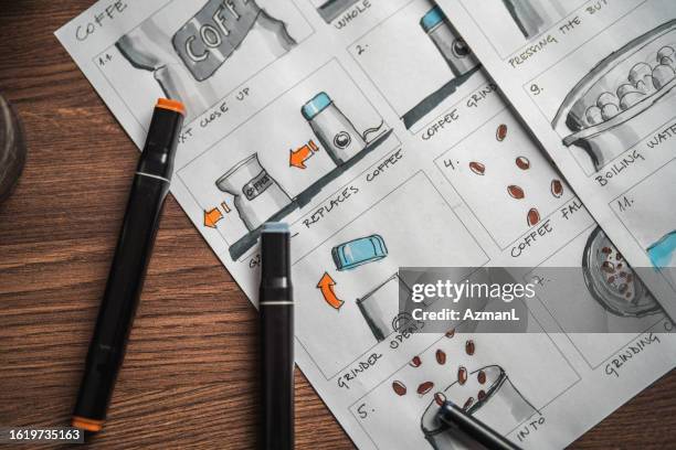 storyboard and colored pencils on the table - scenario stockfoto's en -beelden