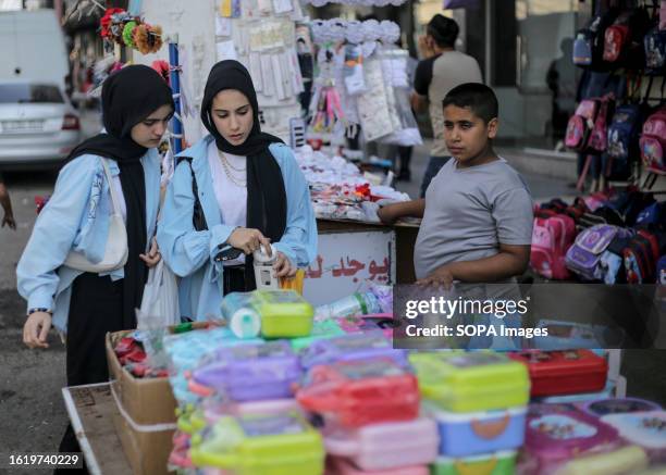 Palestinian women seen shopping in preparation for the new school year in the market in Gaza City.