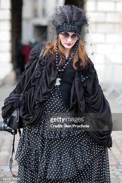 Fashion designer Lucy Sedgeway poses wearing a Biba dress, topshop shoes and a vintage bag with home made gloves, hat, cape and jacket at Somerset...