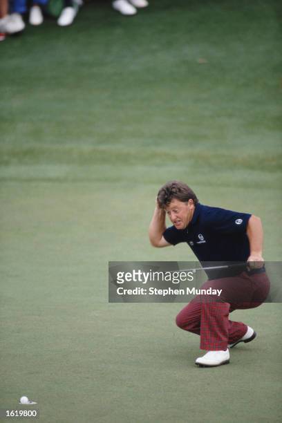 Ian Woosnam of Wales punches the air in triumph as he watches his winning putt on the 18th green during the US Masters at Augusta in Georgia, USA. \...