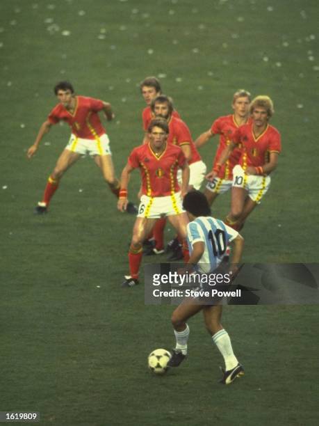 Diego Maradona of Argentina is confronted by a posse of Belgium defenders during the match in the 1982 Wold Cup in Spain. \ Mandatory Credit: Steve...