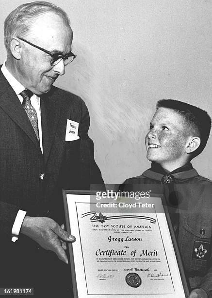 Scout Hero Honored; Receiving a Certificate of Merit at an executive luncheon of the Denver Area Council of Boy Scouts is Denver Scout Gregg Larson...