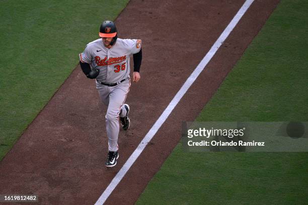 Adley Rutschman of the Baltimore Orioles advances home to score a run against the San Diego Padres during the first inning at PETCO Park on August...