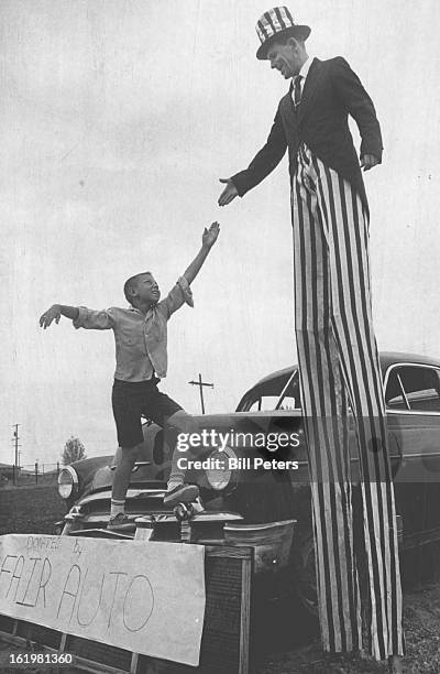 Carnival Set; Jim Kyle, professional entertainer, reaches for hand extended by Robbin Knaub as he rehearses for the carnival planned Saturday at...