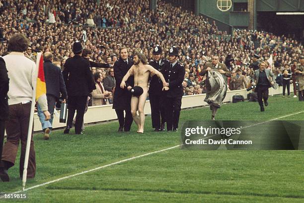 Streaker at Twickenham is discretely led off by police during the England v Wales rugby international, in London, England. \ Mandatory Credit: Tony...