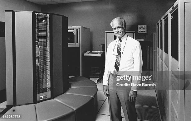 On the far left is the Cray Supercomputer is the middle is William Healy mgr of computing and information at Marathon on the right are the Disk...