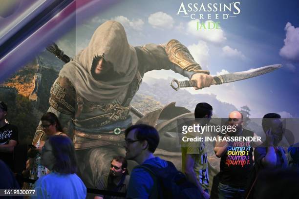Visitors wait for the Assasin's Creed game of the Ubisoft booth at the Gamescom video game fair in Cologne, western Germany on August 24, 2023....