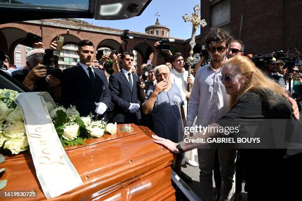 Carla and Nicolo Cutugno , the wife and son of Italian singer-songwriter and composer Toto Cutugno stand by his coffin after his funeral ceremony at...