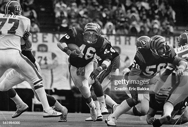 Football - Denver Broncos ; Bengal's running back Pete Johnson barrels through a gaping hole as Broncos' Greg Boyd and Tom Jackson are shoved aside.;