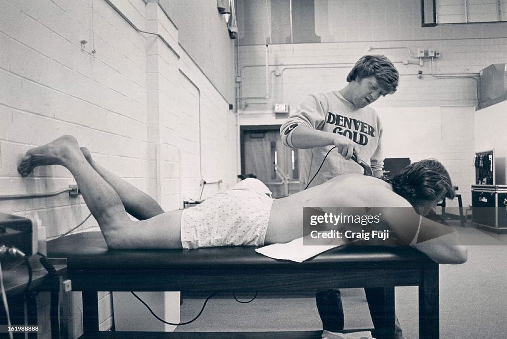 6/1/1983, JUN 2 1983; Niziolek, Bob- Groups; Football; USFL Injuries--Trainer Gary Robertson works o