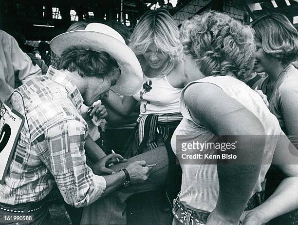 Cheyenne Frontier Days; Don Gay Placates groupies by signing his autograph on girls pant leg;