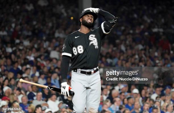 Luis Robert Jr. #88 of the Chicago White Sox reacts after striking out during the eighth inning of a game against the Chicago Cubs at Wrigley Field...