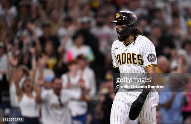 Fernando Tatis Jr. #23 of the San Diego Padres reacts after stealing home against the Baltimore Orioles during the seventh inning at PETCO Park on...