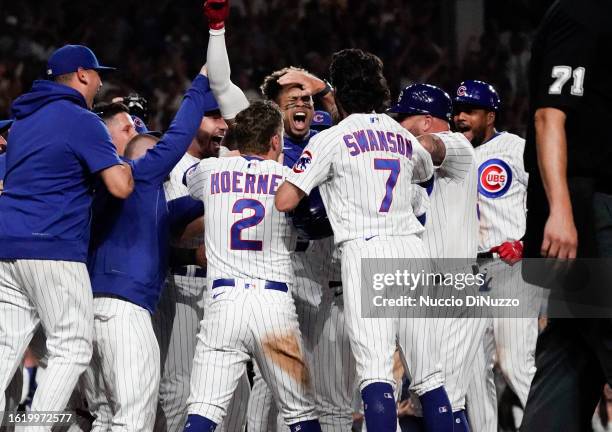 Christopher Morel of the Chicago Cubs is mobbed by teammates following a walk-off three-run home run against the Chicago White Sox at Wrigley Field...
