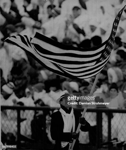 Special to the Denver Post--American flag carrier Lyle Nelson carrier the flag during ceremonies at McMahon Stadium marking the opening of the 1988...