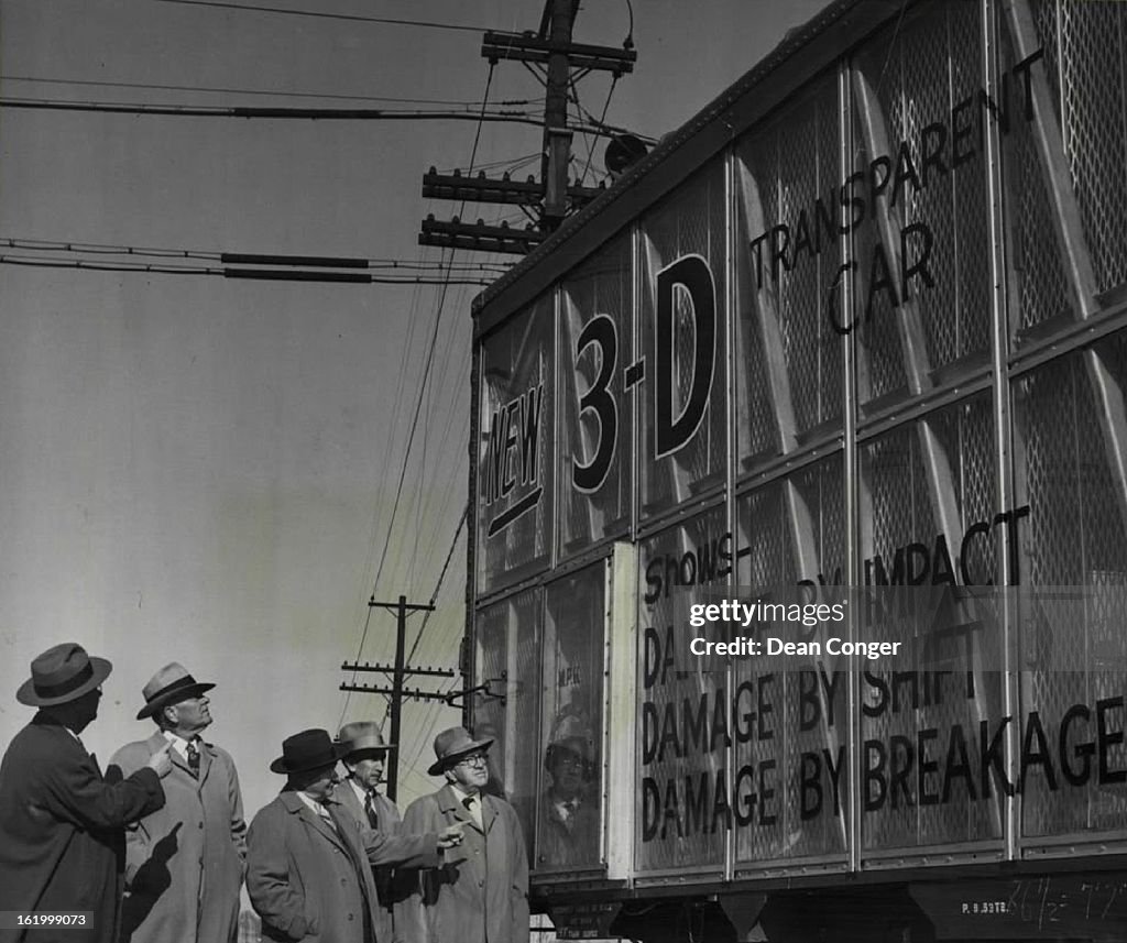 NOV 25 1953, NOV 26 1953; A 3"-D" freight car with Plexiglas sides is inspected by (left to right) J