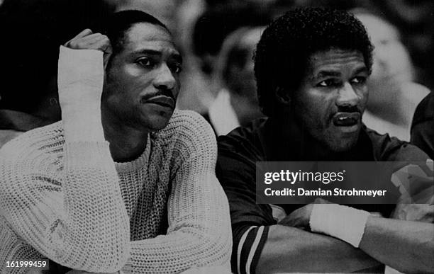 Special Transmission For The Denver Post--Denver's Alex English sits pensively on the Nuggets' bench alongside T.R. Dunn during first - half action...