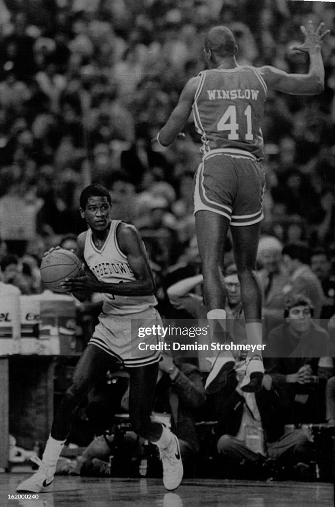 APR 3 1984; Special Transmission for the Denver Post--Georgetown's Reggie Williams moves around an u
