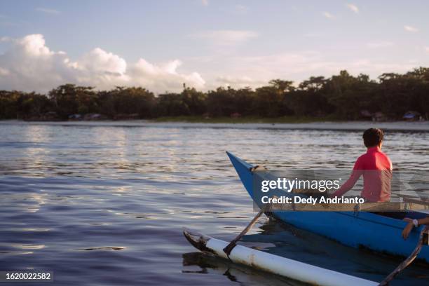 matured southeast asian fisherman going to the sea on a small boat - southeast stock pictures, royalty-free photos & images