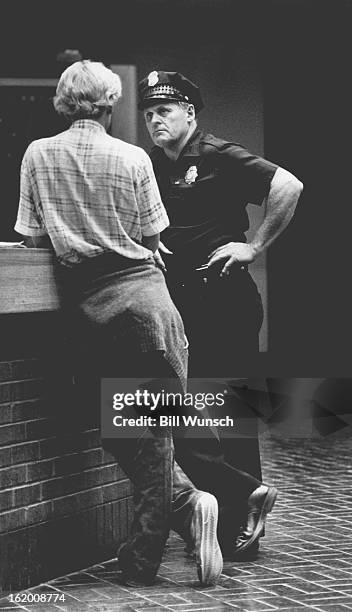 Snider, James H. "Buster"; Listening to story at downtown headquarters;