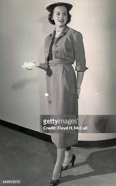 Campbell, Donald C. Mrs; Fashion show model; Hattie Carnegie's pin - check wool costume features self-material detail and tabs on the brief jacket...