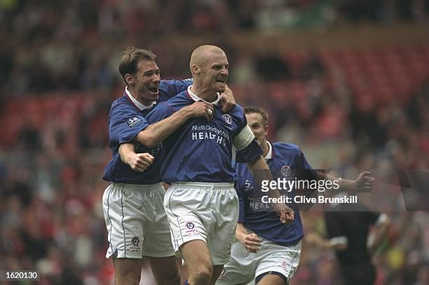 Sean Dyche of Chesterfield receives the congratulations for his goal during the FA Cup Semi-Final against Middlesbrough at Old Trafford in...
