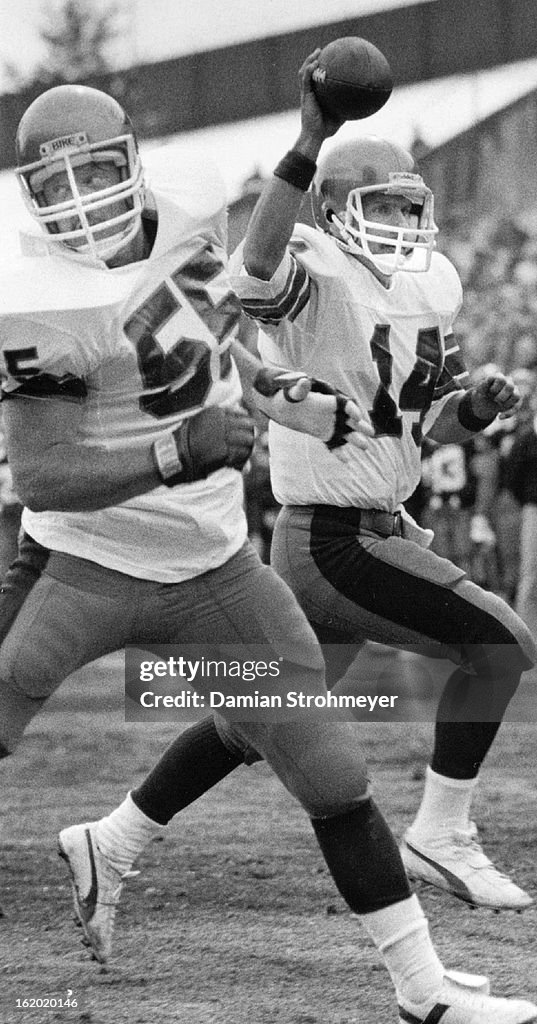 MAR 7 1983; Fusina, Chuck - Groups; Football; Quarterback Chuck Fusina holds the ball aloft while en