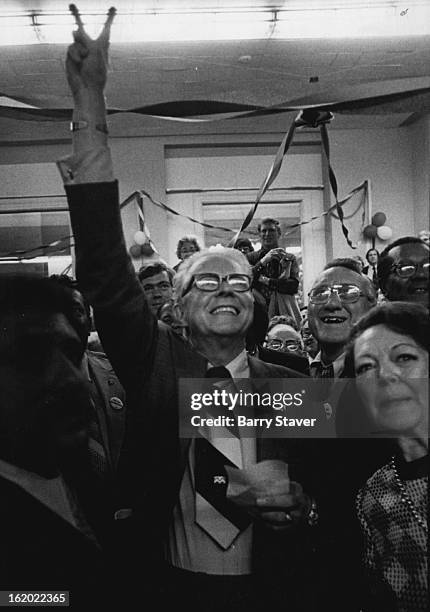 Jubilant Bill McNichols Flasher Victory Sign At News Of Win; With him in the crowd of well-wishers was his wife, Laverne, right.;