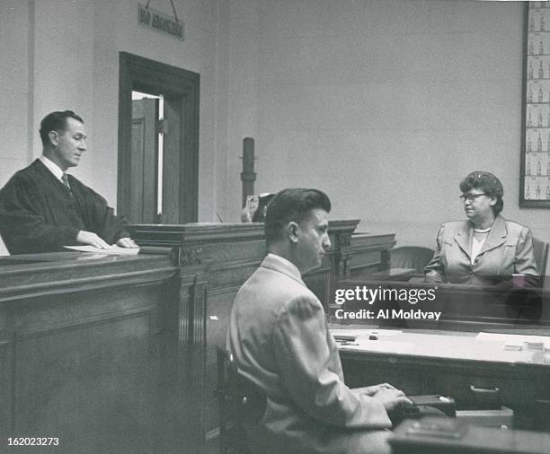 From the witness chair, Mrs. Mary McHugh, a Democratic precinct committeewoman, looks at District Judge Albert T. Frantz during her trial on contempt...