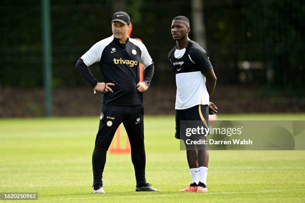 Head Coach Mauricio Pochettino and Moises Caicedo of Chelsea during a training session at the Chelsea Training Ground on August 24, 2023 in Cobham,...