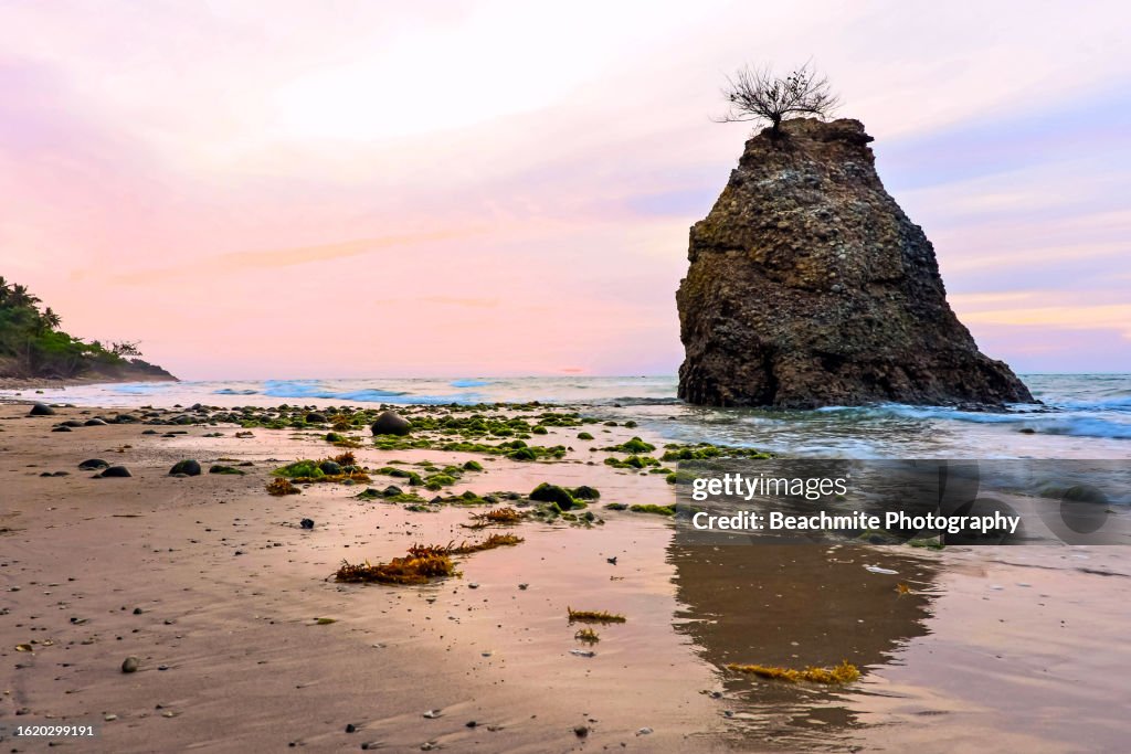 Sunset view of the Batu Luang outcrop on Tempurung beach in Kuala Penyu, Sabah, Malaysia