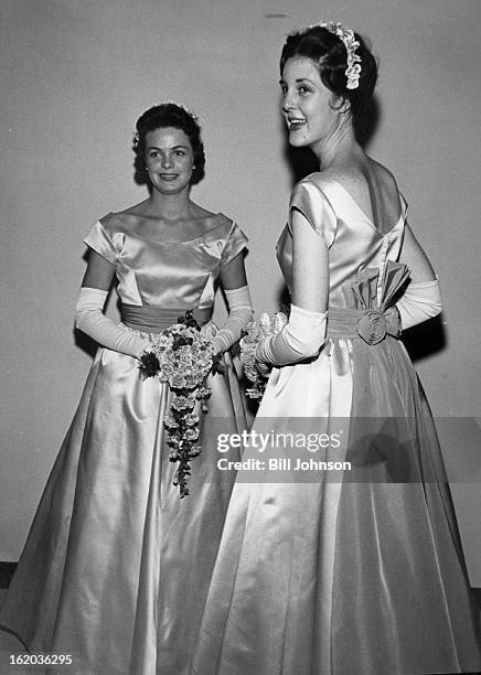 Bridesmaids Saturday were Mrs. Donald A. Ferguson and Miss Polly Sargeant, gowned in shimmering pink satin frocks trimmed with garnet red. They...