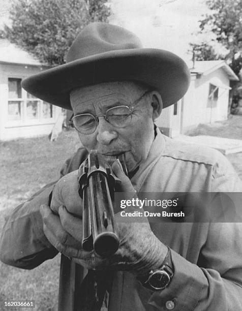 Fred Hesse of Buffalo, Wyo., looks down barrel of gun used by Herbert Brink in killing of Joe Allemand, April 2 in sheep and cattlemen was at...