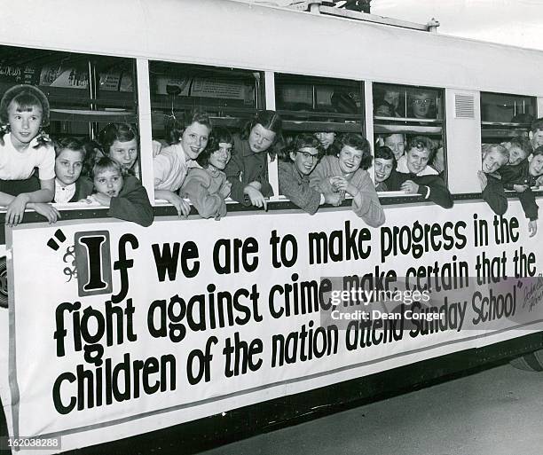 Members of the youth council of Bethel Baptist church crowd up to the windows of a special i white bus furnished by the Denver Tramway Corp. During a...