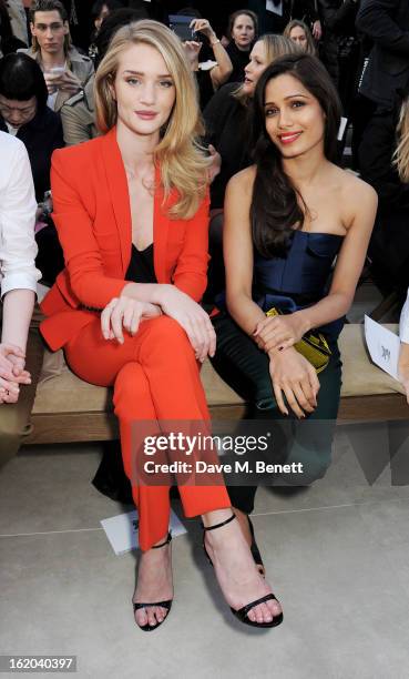Rosie Huntington-Whiteley and Freida Pinto sit in the front row for the Burberry Prorsum Autumn Winter 2013 Womenswear Show at Kensington Gardens on...